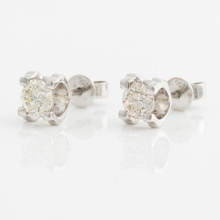 A pair of 18K gold earrings with round brilliant-cut diamonds.