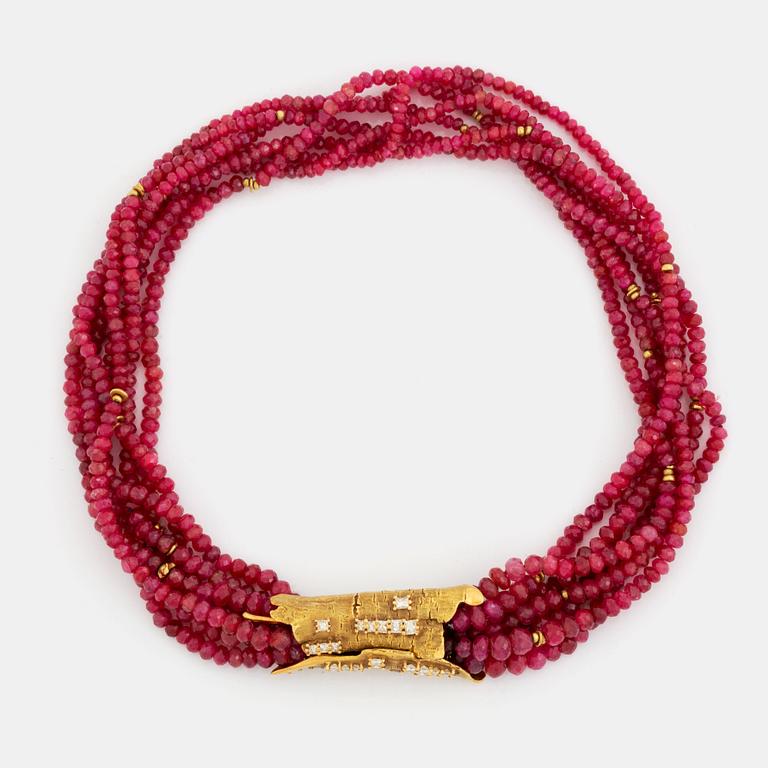 A W Nussberger ruby necklace with an 18K gold clasp set with princess-cut diamonds.