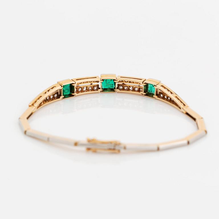 An 18K gold and platinum bracelet set with step-cut emeralds and old- and eight-cut diamonds.