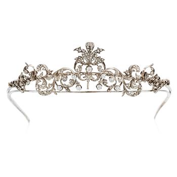 572. An 18K gold and silver tiara composed of scroll motifs set  with old- and rose-cut diamonds.