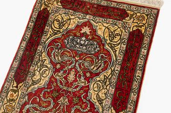 A silk and metal Hereke rug, c. 86 x 52 cm.
