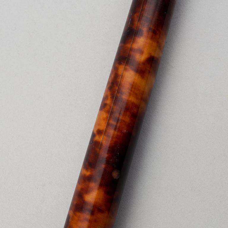 A tortoise imitation veneer, bone, and 14 ct gold walking stick.