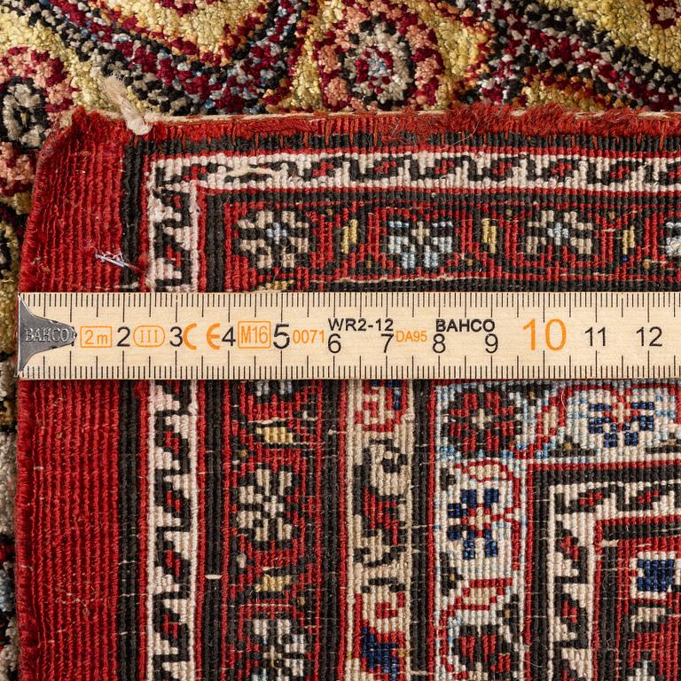 A semi-antique silk Qum rug, central Persia 221 x 138 cm.