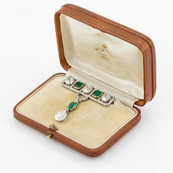 An impressive platinum, step-cut emerald and old-cut diamond brooch by W.A. Bolin likely Moscow 1912-1917. No hallmarks.