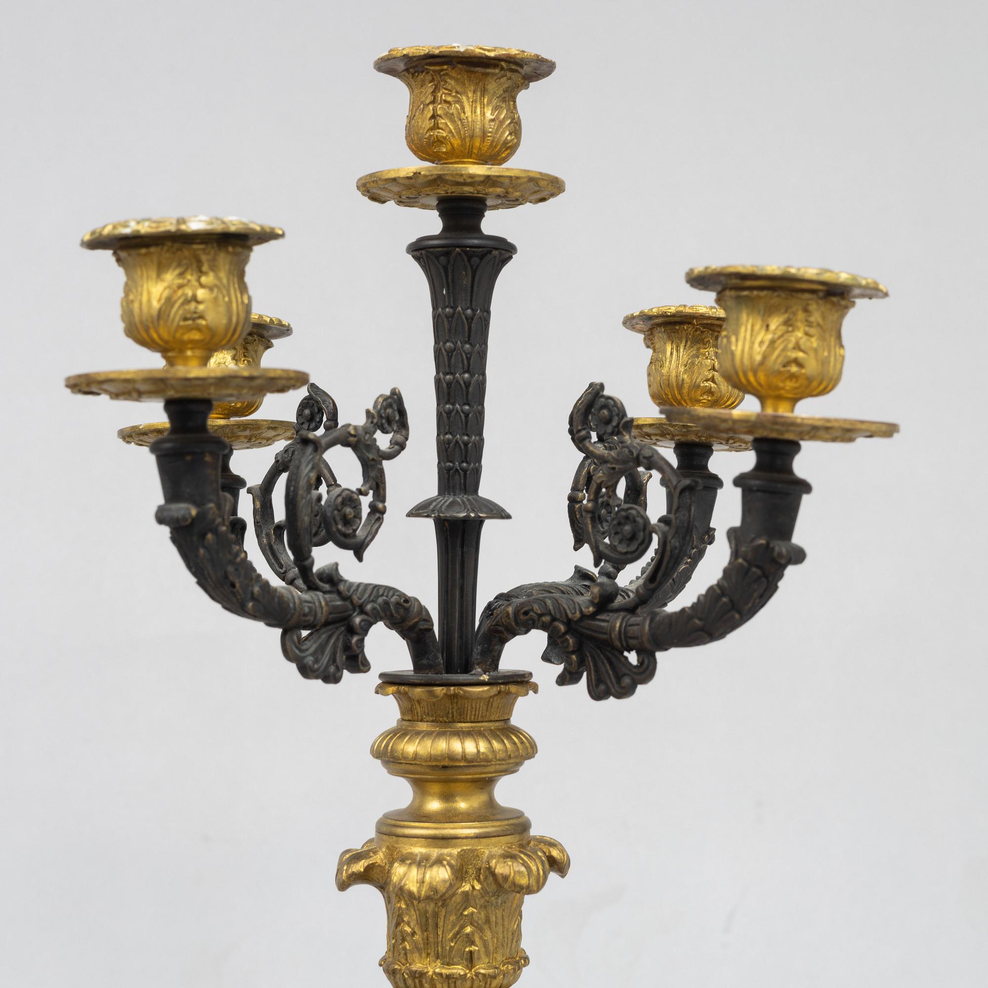 A pair of French Empire-style patinated and gilt bronze five-light candelabra, later part 19th century.