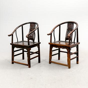 A pair of Chinese hardwood armchairs, circa 1900.