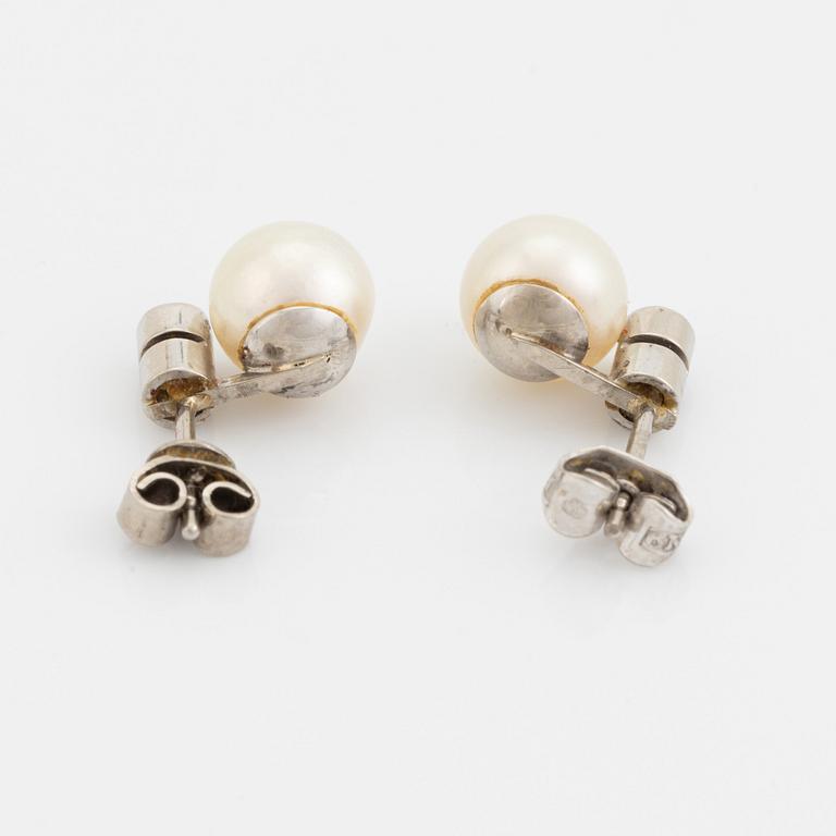 White gold earrings and ring with pearl and white stones.