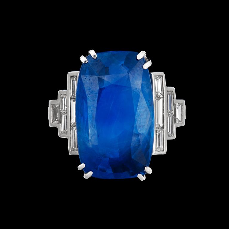 An untreated sapphire ring, 15.80 cts, set with step cut diamonds.