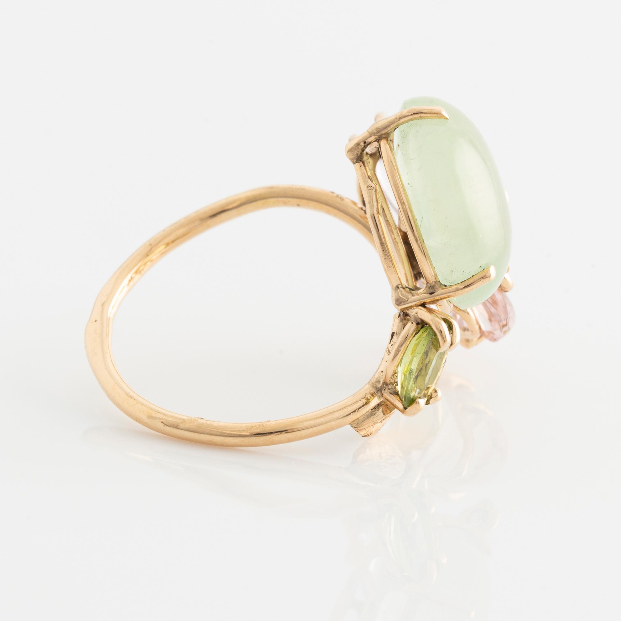 Ring with cabochon-cut prehnite, cut tourmaline in the shape of a butterfly, peridot, and brilliant-cut diamonds.