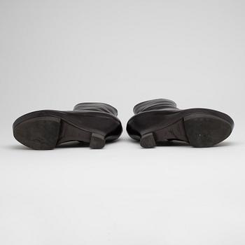 YVES SAINT LAURENT, a pair of brown leather wedge heeled platform boots.