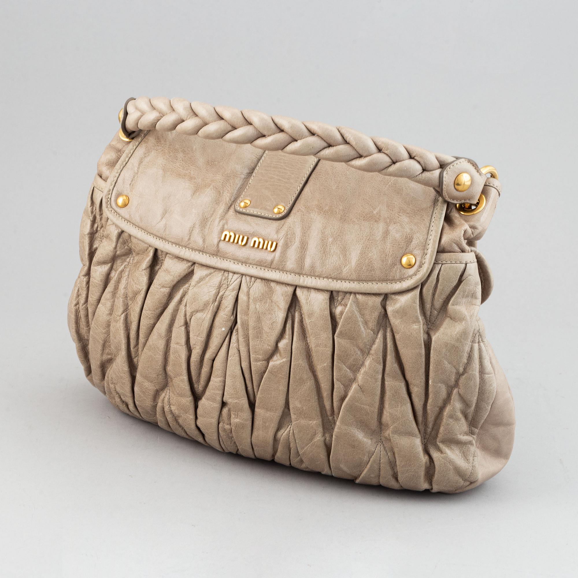 Miu Miu, a light leather handbag.