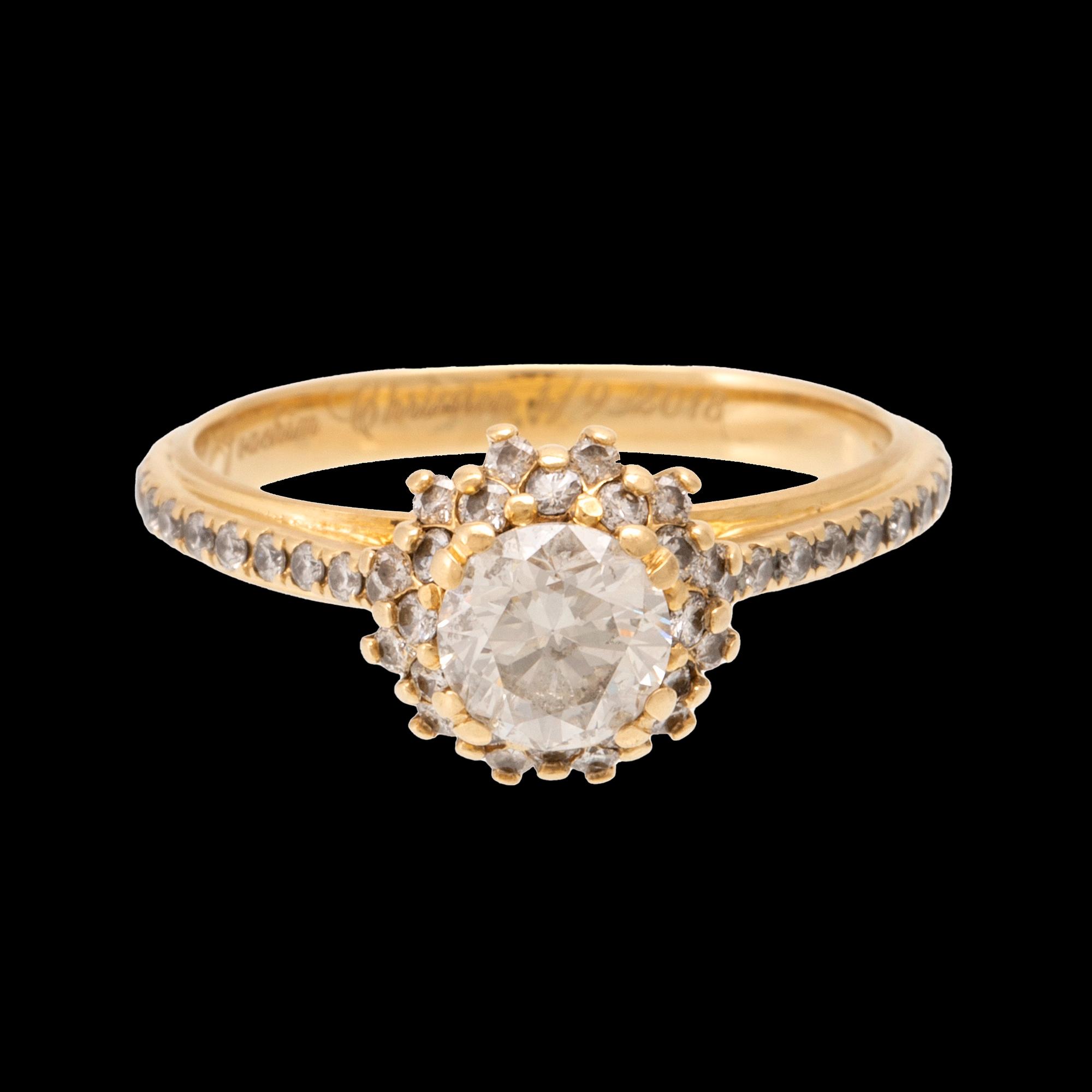 An 18K gold ring set with round brilliant-cut diamonds.