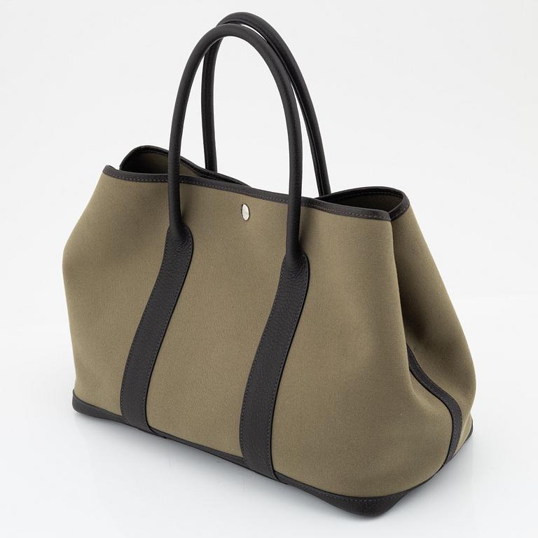 Hermès, a green canvas and brown leather 'Garden Party' bag.