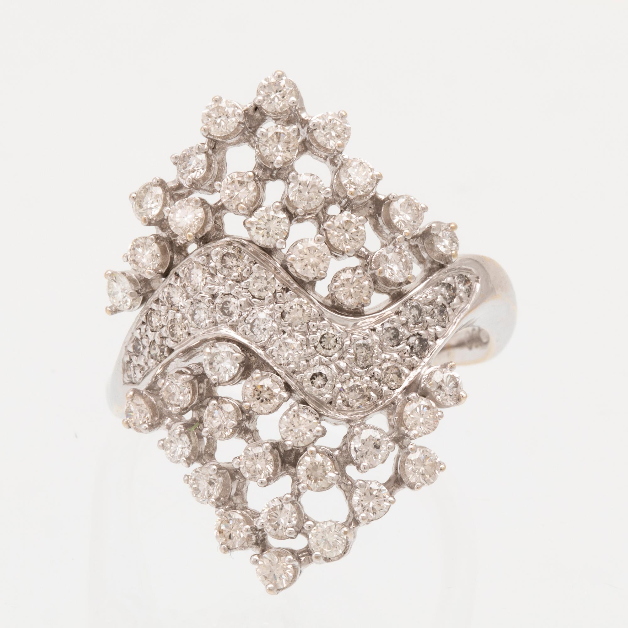 An 18K white gold ring set with round brilliant cut diamonds.
