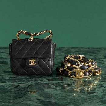 Belt with mini flap-bag by Chanel.