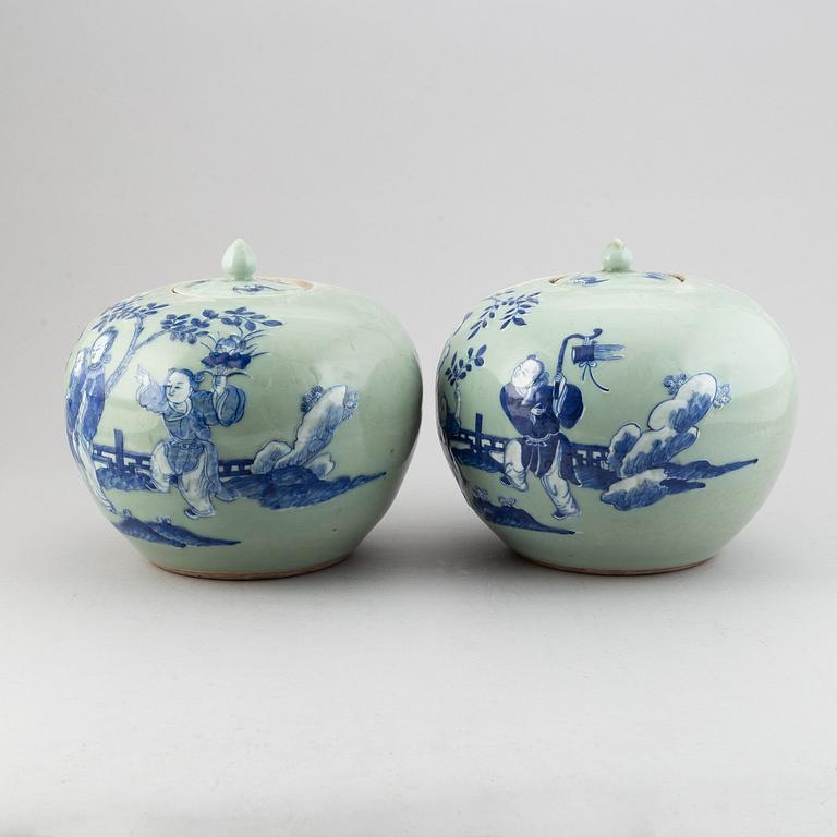 A pair of Chinese celadon glazed and blue and white jars with covers, 20th century.