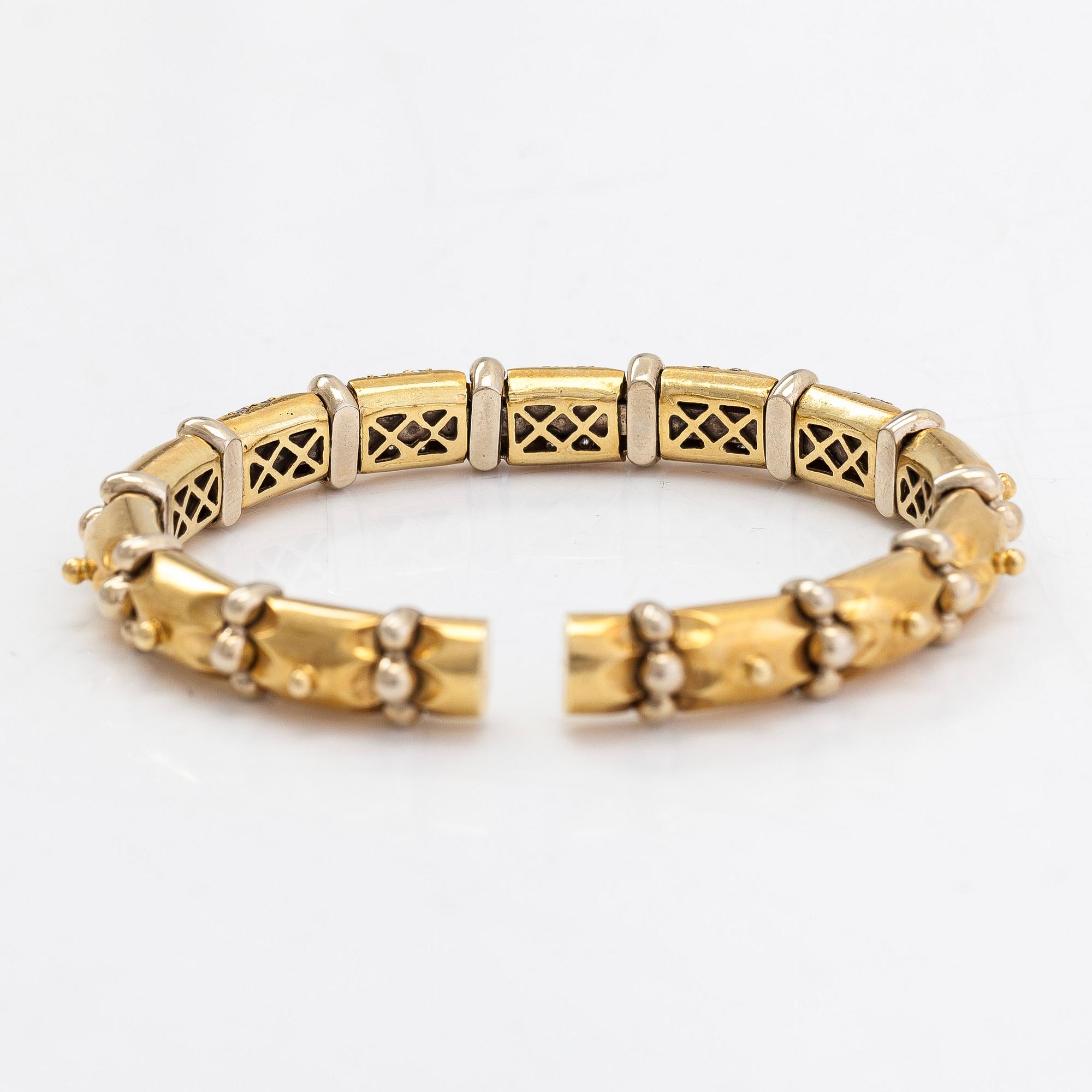 An ca. 18K gold bangle with diamonds approx. 0.50 ct. in total and rubies.