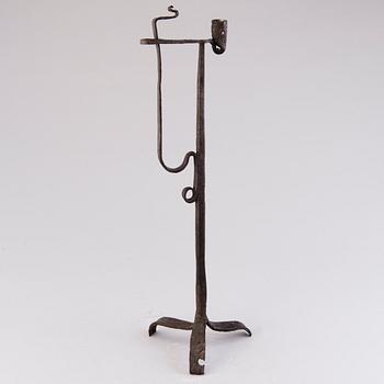 A 18th century wrought iron rush light and candle holder.