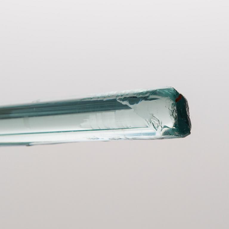 A greenish glass walking stick.