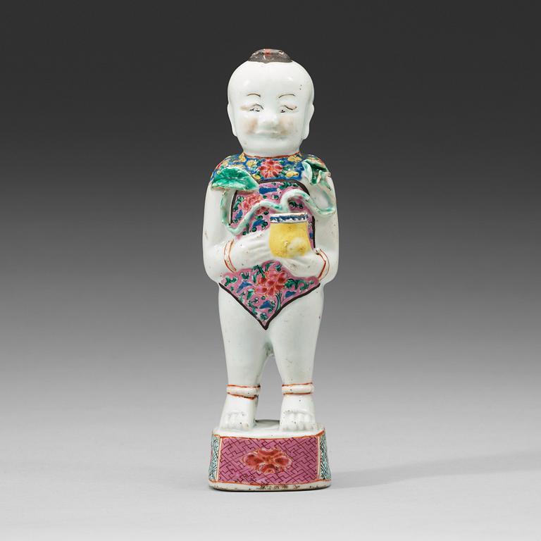 A famille rose figure of a boy, Qing dynasty, 18th Century.