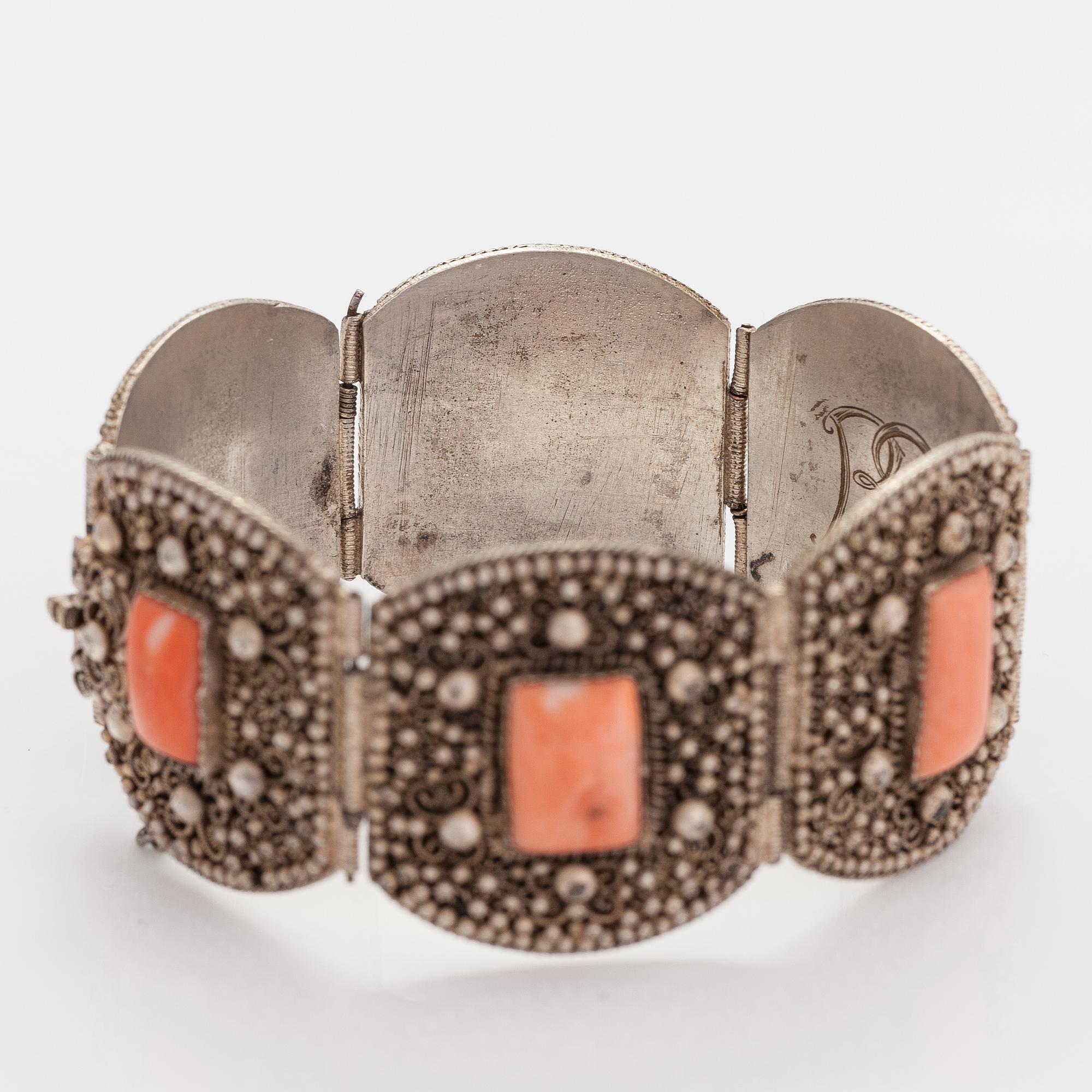 A silver bracelet with corals.