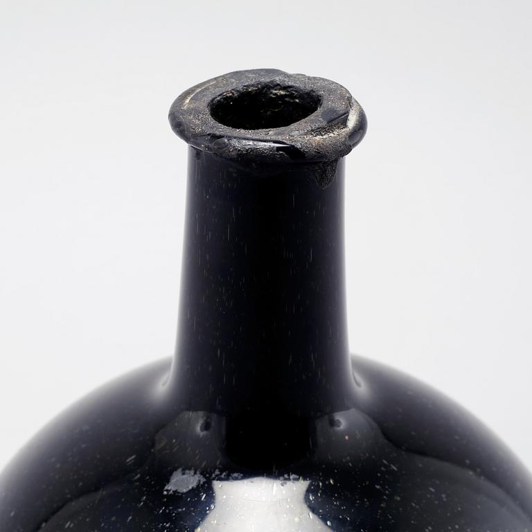 An 18th century glass bottle.