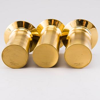TAPIO WIRKKALA, A set of three brass candleholders, all marked Kultakeskus Oy Made in Finland, Design Tapio Wirkkala.