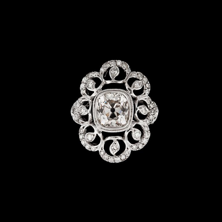An old-cut diamond ring. Center stone circa 1.94 cts, surrounded by 70 smaller diamonds with different cuts.