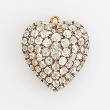 A pendant/locket in 18K gold set with old-cut diamonds, in the form of a heart.