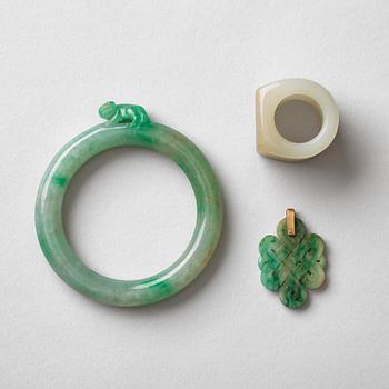 496. A nephrite armring, archers ring and a pendant, China, early 20th Century.