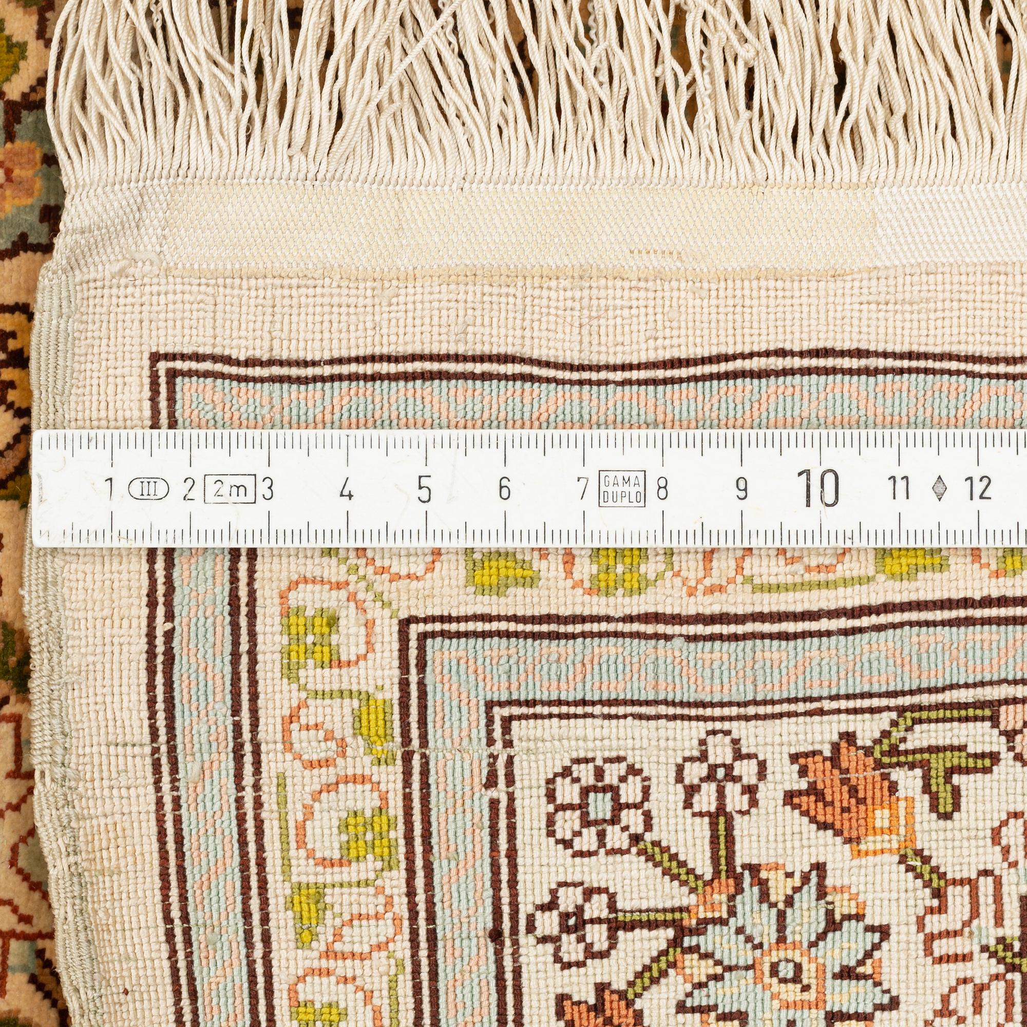 A silk Hereke rug, circa 104 x 70 cm.