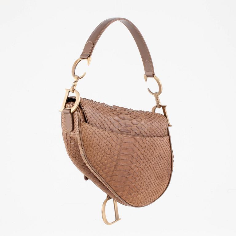 CHRISTIAN DIOR, a gold toned leather handbag, "Saddle bag".