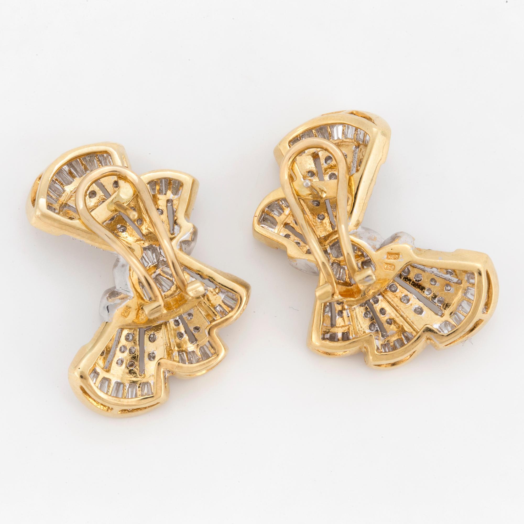A pair of earrings in the shape of bows set with round, brilliant and tapered, baguette-cut diamonds.