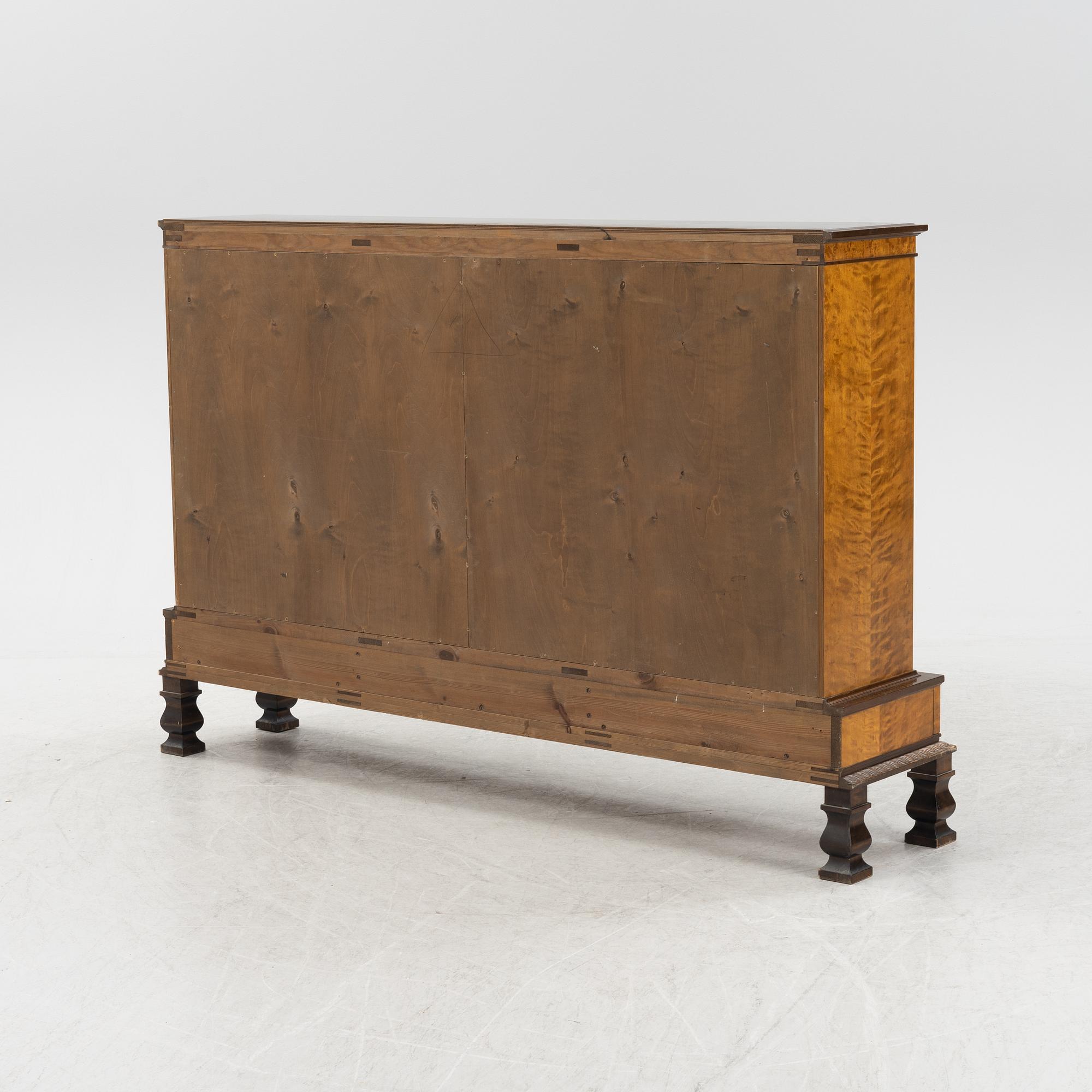 A stained birch veneered book cabinet, first half of the 20th Century.