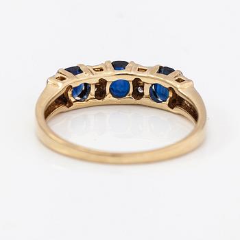 A 14K gold ring with diamonds ca. 0.05 ct and sapphires. Finnish import marks 1990.