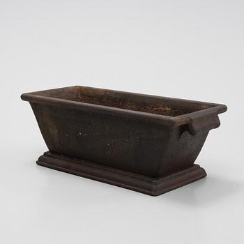 A cast iron plant pot, 20th Century.
