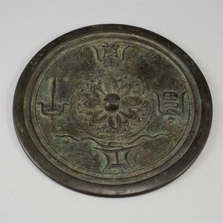 A large bronze mirror, Ming dynasty or earlier.