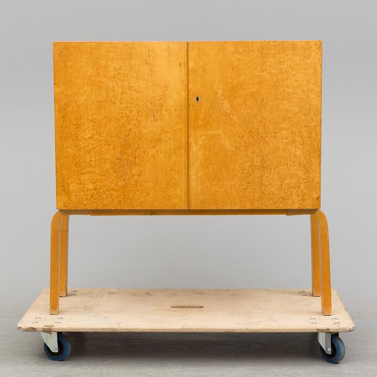 ALVAR AALTO, a mid 20th century burr birch veneered cabinet, model 810, Finland.