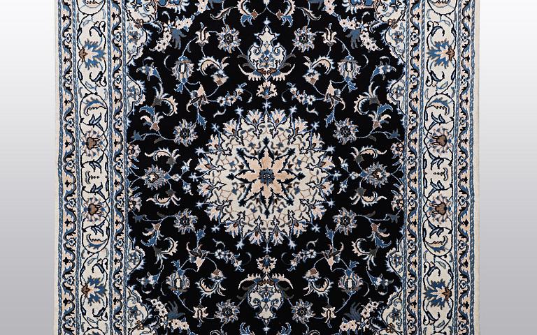 A rug, Nain, part silk, ca 242 x 167 cm.