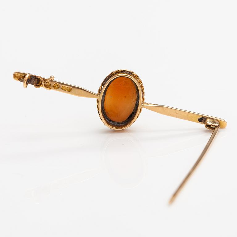 Two brooches and a ring, 14K and 18K gold and sea shell cameos.