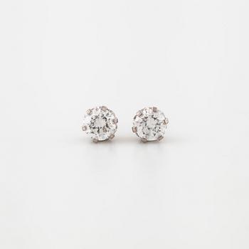 A pair of brilliant cut diamond earrings.