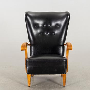 A 1940's - 50's easy chair in black leather, Scandinavian.