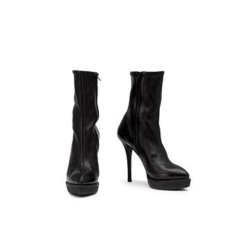 GUCCI, a pair of black leather boots.