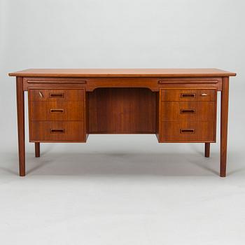A wooden mid 20th century desk.