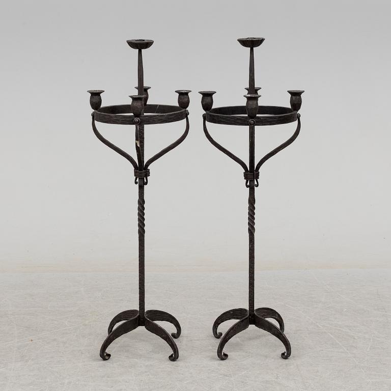 a pair of iron floor candle sticks, 20th century.