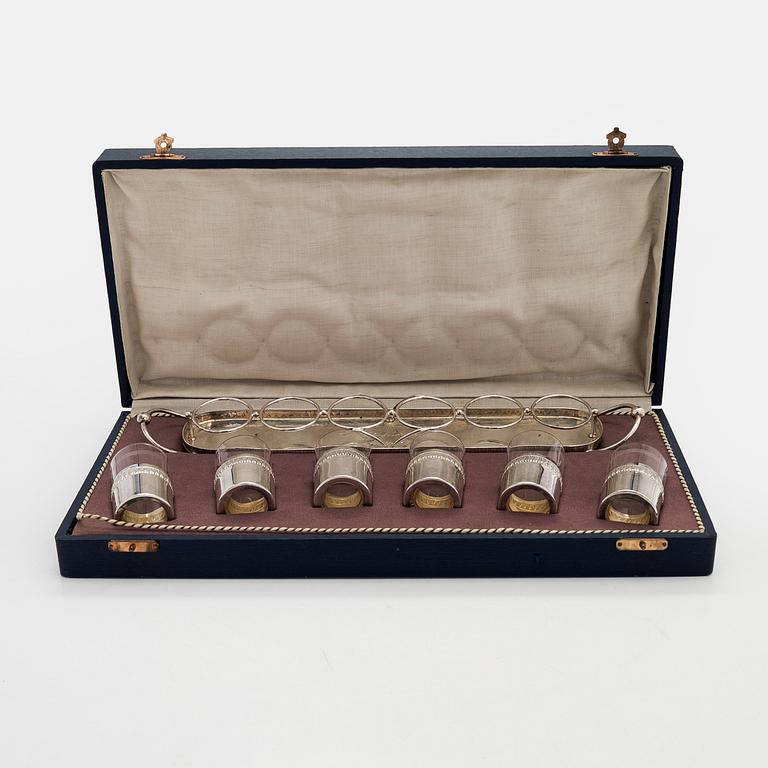 A set of six shot glasses with a tray in original fitted box, silver and glass, likely Norway 1910s.