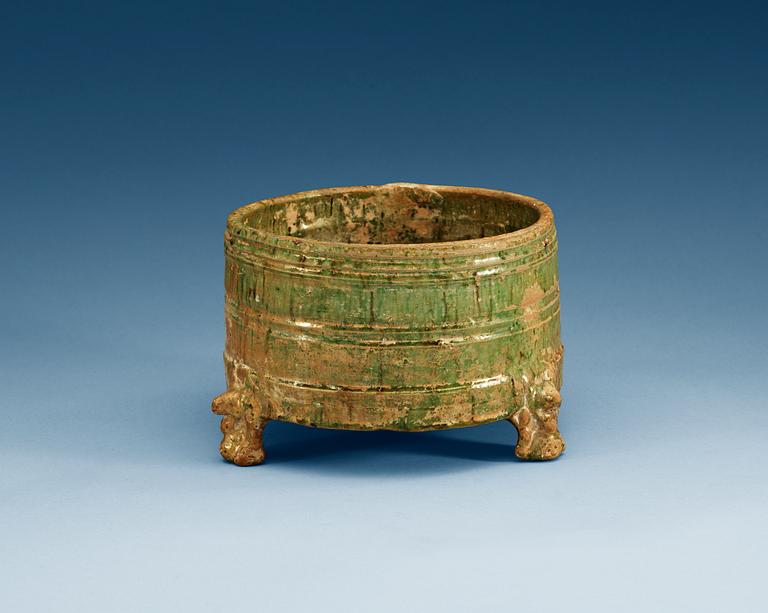 A green glazed tripod censer, Han dynasty (206 BC – 220 AD).