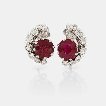 A pair of 18K white gold WA Bolin earrings set with faceted rubies and round brilliant- and eight-cut diamonds.