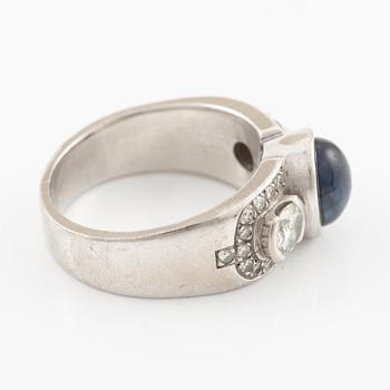 Ring in 18K white gold set with a cabochon-cut sapphire and brilliant-cut diamonds, Kenneth Magnell.