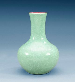1435. A turkoise-ground white enamelled vase, Qing dynasty (1644-1912) with Qianlong four character mark.